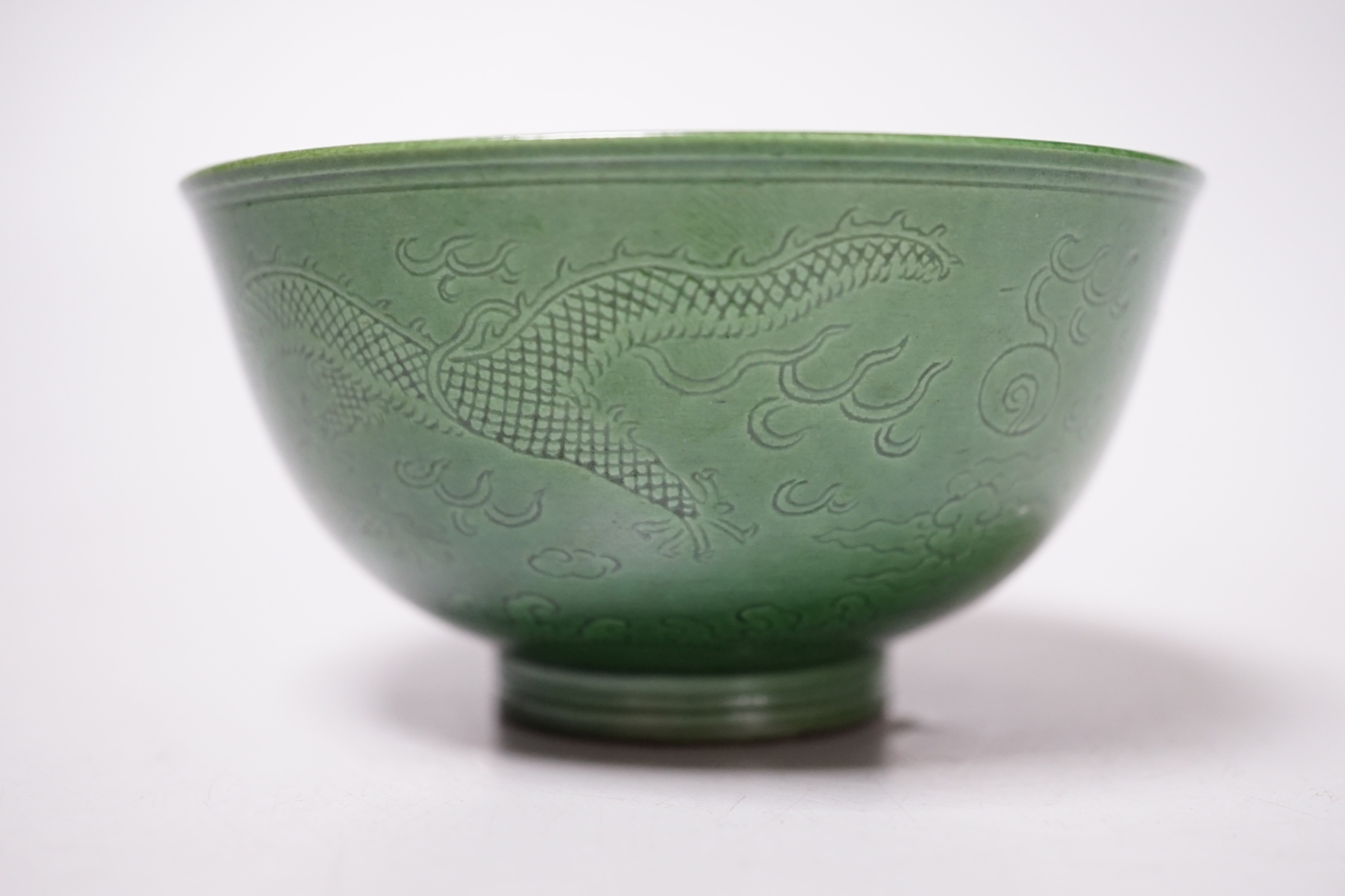 A Chinese green glazed ‘dragon’ tea bowl, 10cm diameter